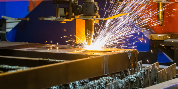 Industrial metal cutting machine cutting a steel plate with sparks flying